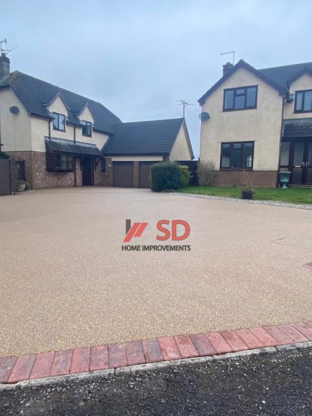 Gold resin driveway with paving border in Oldland Common