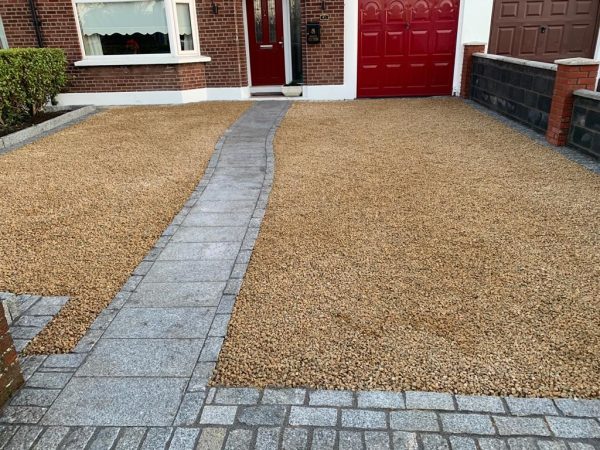 Gravel being laid on a driveway in Charfield