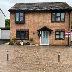 Driveway with Autumn Block Paving and Charcoal Edge in Longwell…