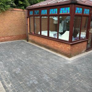 Patio with Charcoal and Natural Grey Block Paving in Longwell…